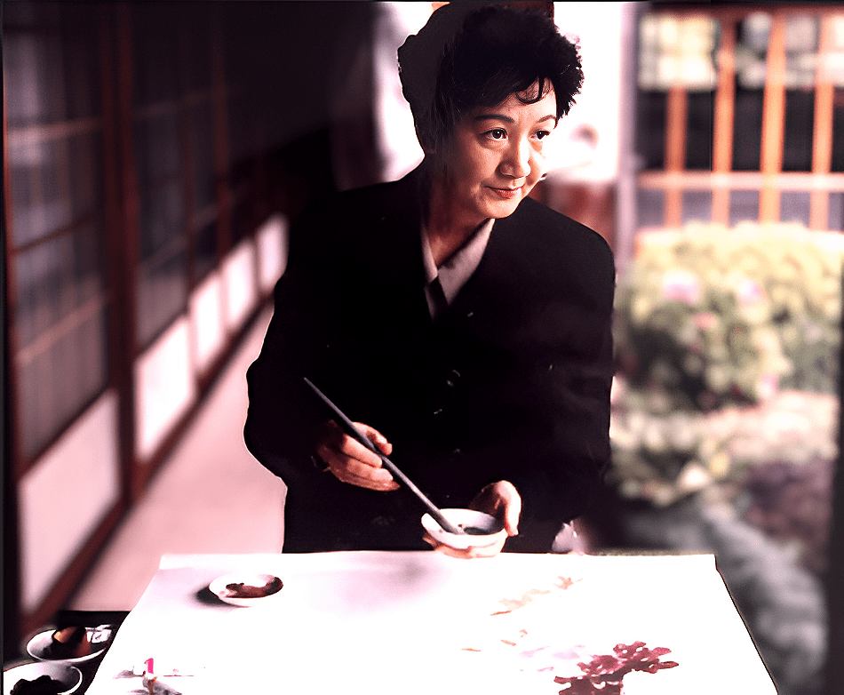 Artist painting flowers with brush at table